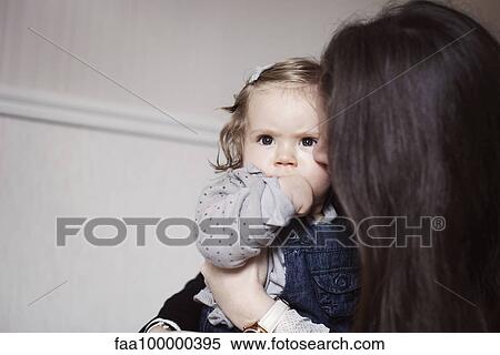 Mother comforting sulky baby girl View Large Photo Image Stock Photography - Mother comforting sulky baby girl. Fotosearch