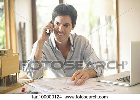 Picture - Office worker talking on cell phone. Fotosearch