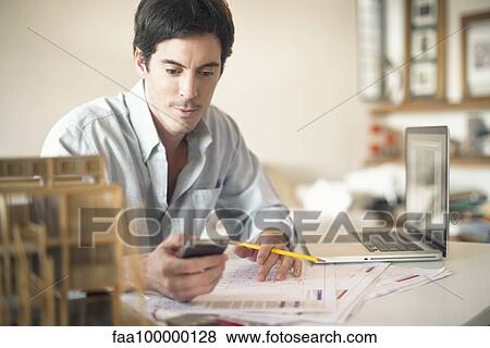 Office worker using cell phone View Large Photo Image Stock Photo - Office worker using cell phone. Fotosearch
