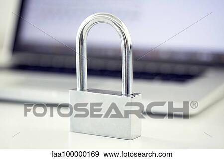 Padlock in front of laptop computer representing internet security View Large Photo Image Stock Photo - Padlock in front of laptop computer representing internet security. Fotosearch