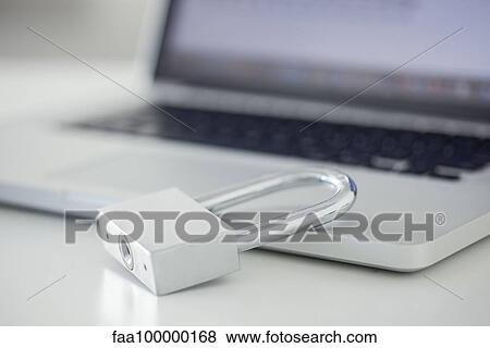 Stock Photo - Padlock resting on laptop computer. Fotosearch