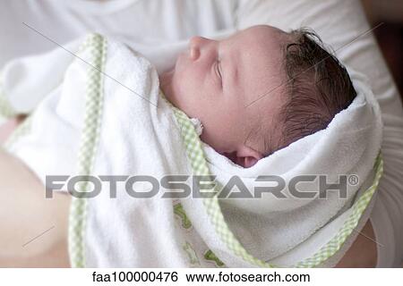 Sleeping new born baby swaddled in blanket View Large Photo Image Stock Photograph - Sleeping new born baby swaddled in blanket. Fotosearch