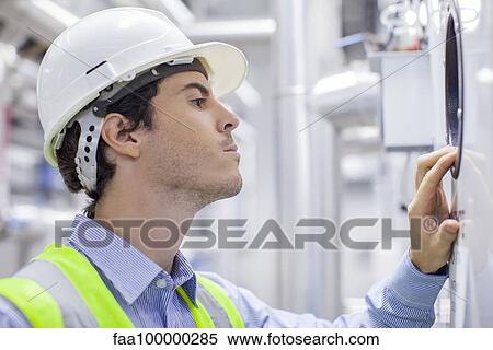 Technician checking industrial plant equipment View Large Photo Image Stock Photography - Technician checking industrial plant equipment. Fotosearch
