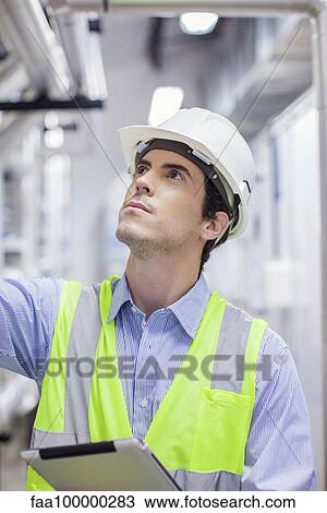 Technician inspecting industrial plant View Large Photo Image Stock Image - Technician inspecting industrial plant. Fotosearch