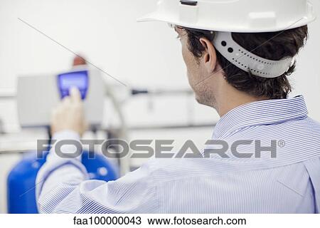 Technician operating industrial equipment View Large Photo Image Stock Image - Technician operating industrial equipment. Fotosearch