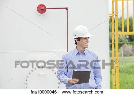 Stock Image - Technician working at industrial site. Fotosearch