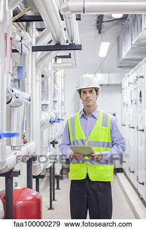 Technician working in industrial plant View Large Photo Image Stock Photo - Technician working in industrial plant. Fotosearch