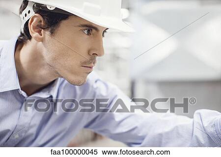 Stock Photography - Technician working in industrial plant. Fotosearch