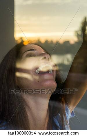 Picture - Woman experiencing thrill of waking up in new place. Fotosearch