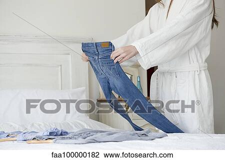Woman laying out clothes for the day, cropped View Large Photo Image Stock Image - Woman laying out clothes for the day, cropped. Fotosearch