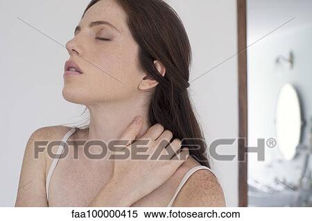 Woman massaging neck View Large Photo Image Stock Photography - Woman massaging neck. Fotosearch