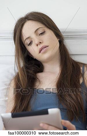 Woman using digital tablet View Large Photo Image Stock Image - Woman using digital tablet. Fotosearch