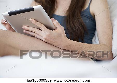 Woman using digital tablet View Large Photo Image Stock Photo - Woman using digital tablet. Fotosearch