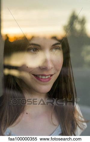 Stock Photography - Woman watching setting sun. Fotosearch