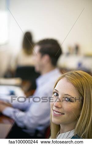 Woman working in office, smiling View Large Photo Image Picture - Woman working in office, smiling. Fotosearch