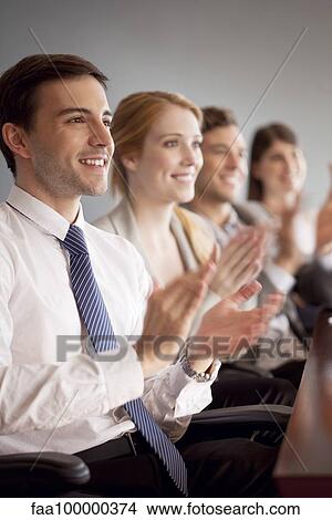 Young business professionals applauding during presentation View Large Photo Image Picture - Young business professionals applauding during presentation. Fotosearch