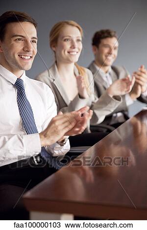 Young business professionals applauding at conclusion of presentation View Large Photo Image Stock Image - Young business professionals applauding at conclusion of presentation. Fotosearch