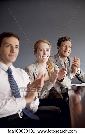 Young business professionals applauding at conclusion of presentation View Large Photo Image Stock Photography - Young business professionals applauding at conclusion of presentation. Fotosearch