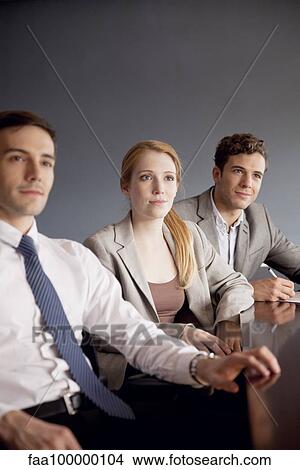 Picture - Young business professionals attending presentation. Fotosearch