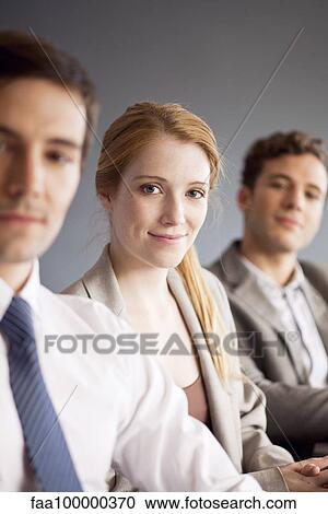 Young businesswoman with male colleagues, portrait View Large Photo Image Stock Image - Young businesswoman with male colleagues, portrait. Fotosearch