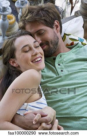 Young couple reclining together View Large Photo Image Stock Image - Young couple reclining together. Fotosearch