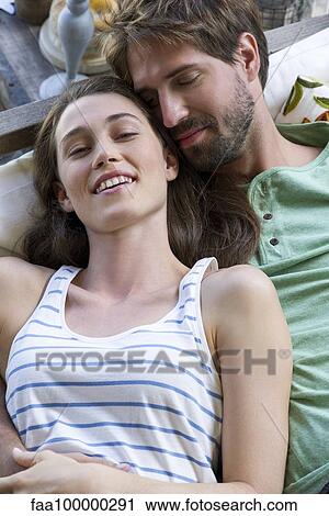 Young couple reclining together View Large Photo Image Stock Image - Young couple reclining together. Fotosearch