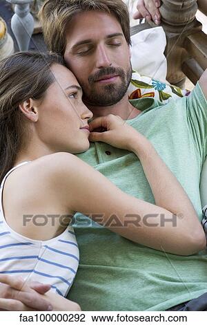 Young couple reclining together View Large Photo Image Stock Image - Young couple reclining together. Fotosearch