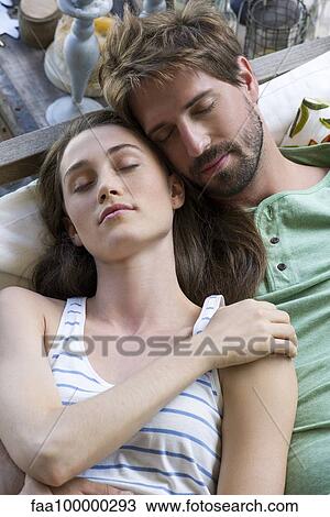 Young couple reclining together View Large Photo Image Stock Image - Young couple reclining together. Fotosearch
