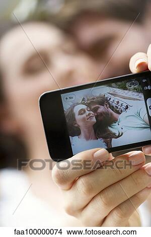 Young couple taking selfie with smartphone View Large Photo Image Picture - Young couple taking selfie with smartphone. Fotosearch