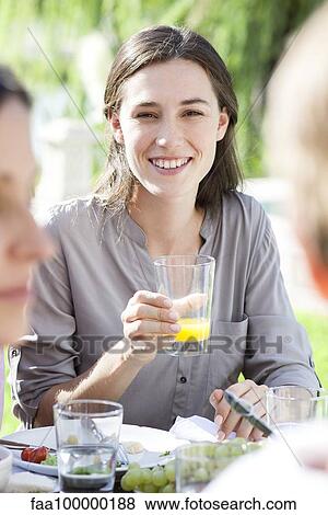 Young woman enjoying picnic outdoors View Large Photo Image Stock Photo - Young woman enjoying picnic outdoors. Fotosearch