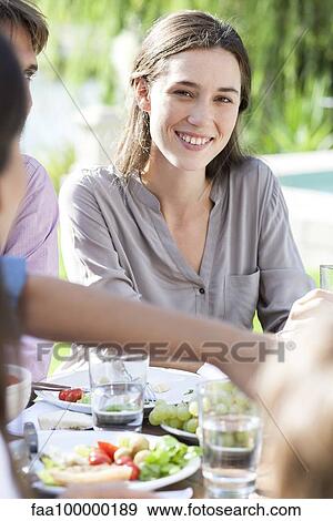 Young woman enjoying picnic outdoors View Large Photo Image Stock Photo - Young woman enjoying picnic outdoors. Fotosearch