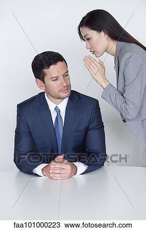 Assistant whispering in executive's ear View Large Photo Image Stock Image - Assistant whispering in executive's ear. Fotosearch