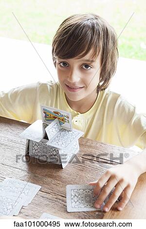 Boy building house of cards View Large Photo Image Stock Photography - Boy building house of cards. Fotosearch
