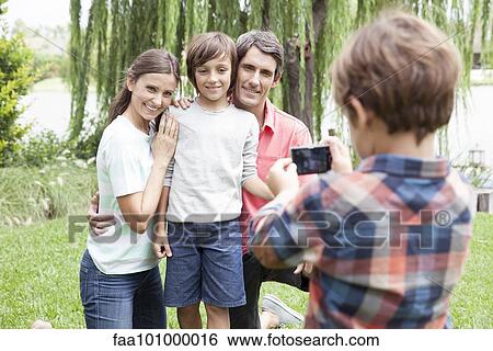 Boy photographing family View Large Photo Image Stock Photograph - Boy photographing family. Fotosearch