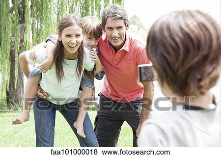 Boy taking snapshot of his family View Large Photo Image Stock Photo - Boy taking snapshot of his family. Fotosearch