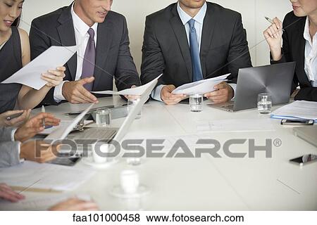 Stock Photo - Business associates brainstorming in meeting. Fotosearch