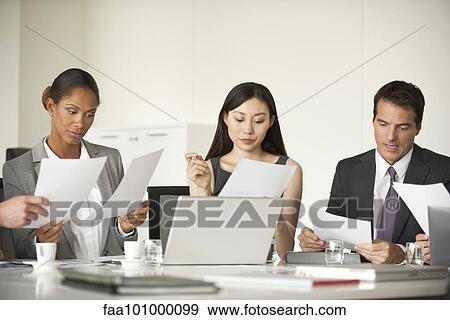 Business associates collaborating View Large Photo Image Stock Photo - Business associates collaborating. Fotosearch