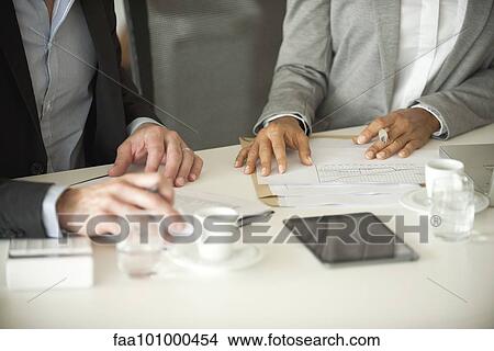 "Business associates working together, cropped" View Large Photo Image Picture - "Business associates working together, cropped". Fotosearch