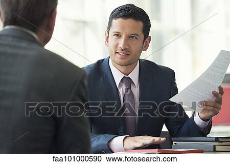 Businessman discussing contract with client View Large Photo Image Stock Image - Businessman discussing contract with client. Fotosearch