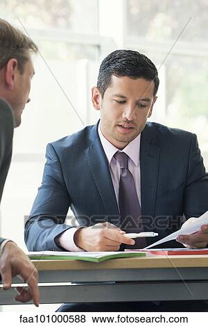 Businessman discussing contract with client View Large Photo Image Stock Photo - Businessman discussing contract with client. Fotosearch
