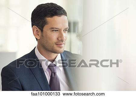 Businessman looking away in thought View Large Photo Image Stock Image - Businessman looking away in thought. Fotosearch