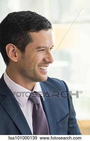 Stock Photo - "Businessman looking away, smiling". Fotosearch