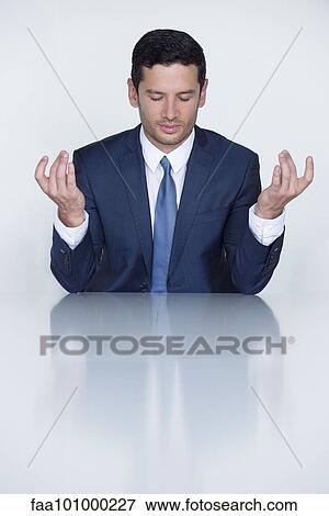 Businessman meditating View Large Photo Image Stock Photo - Businessman meditating. Fotosearch
