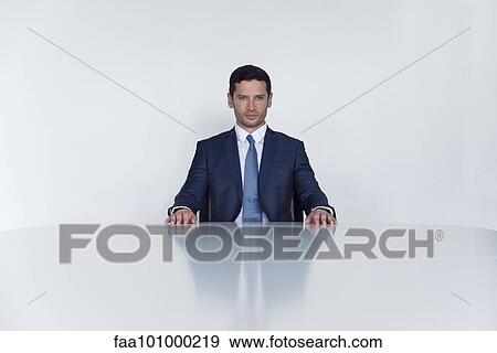 "Businessman seated at table, portrait" View Large Photo Image Stock Photo - "Businessman seated at table, portrait". Fotosearch