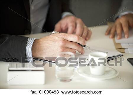 Stock Image - Businessman signing document. Fotosearch