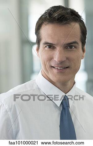 Stock Image - "Businessman smiling, portrait". Fotosearch