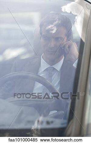 Businessman talking on cell phone while driving View Large Photo Image Stock Photography - Businessman talking on cell phone while driving. Fotosearch