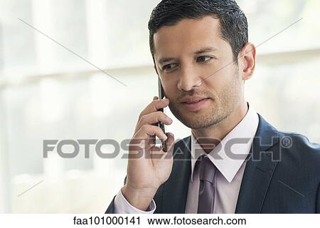 Businessman using cell phone View Large Photo Image Stock Image - Businessman using cell phone. Fotosearch