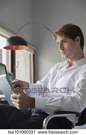 Businessman using digital tablet View Large Photo Image Stock Photo - Businessman using digital tablet. Fotosearch