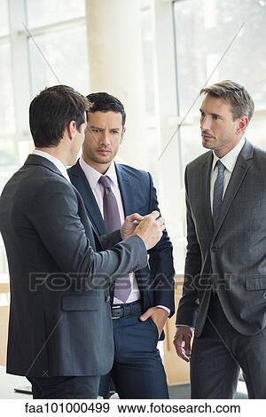 Businessmen engaged in serious discussion View Large Photo Image Stock Photo - Businessmen engaged in serious discussion. Fotosearch